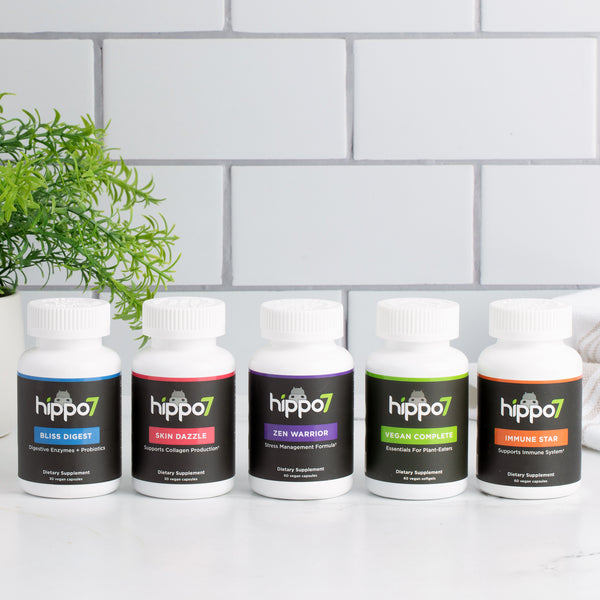 Wellness Bundle on a countertop with tile in the background and leaf showing
