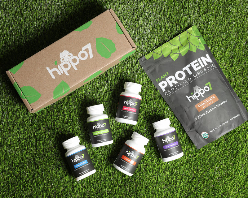 Hippo7 supplements including zen warrior stress and plant protein and vegan complete shot from above on turf with eco box