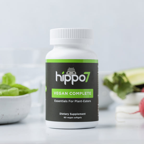 Front shot of Hippo7 Vegan Complete multivitamin in a kitchen next to a salad and radishes., cover image